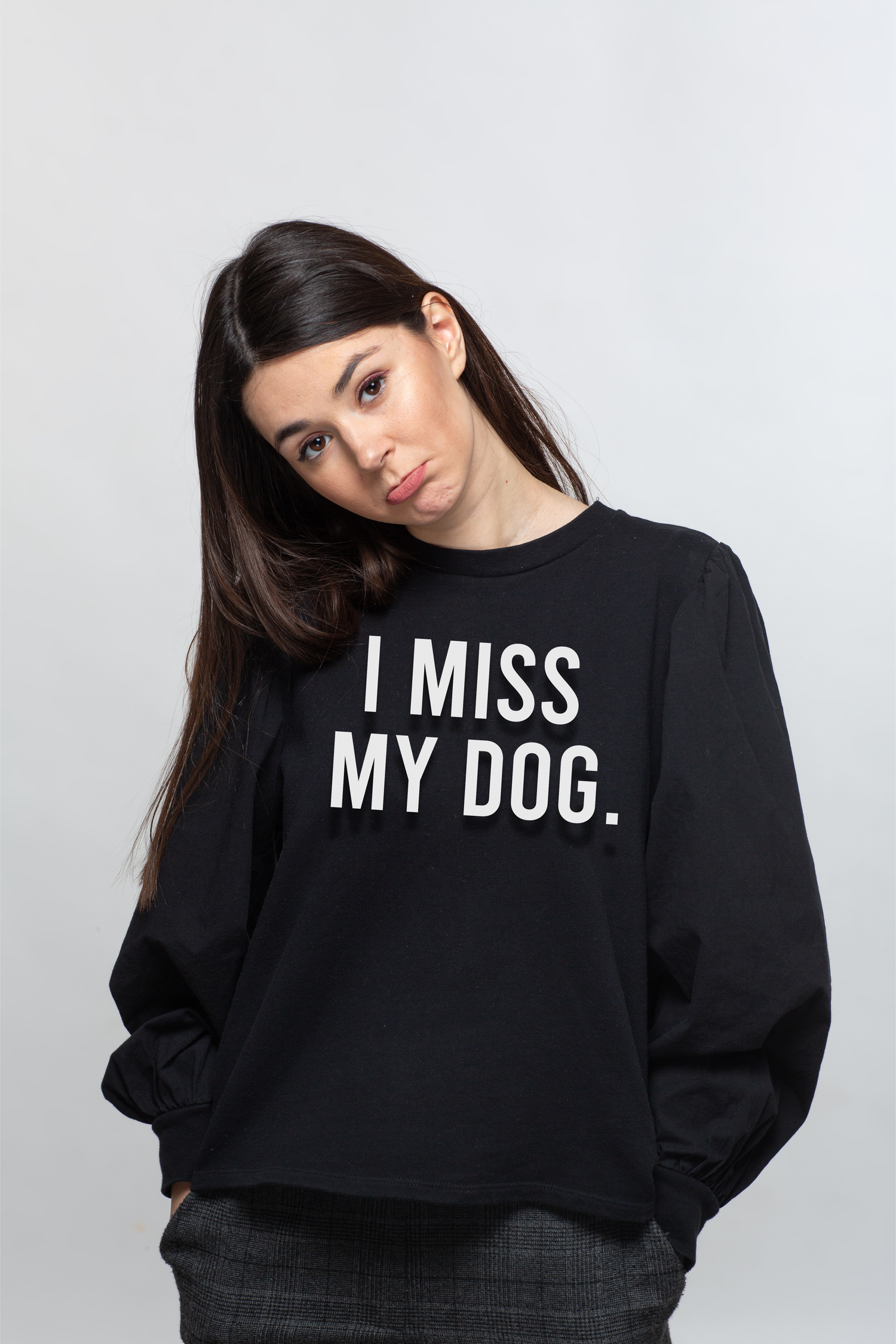 Person wearing a black sweatshirt with 'I MISS MY DOG.' white text on the front center chest.